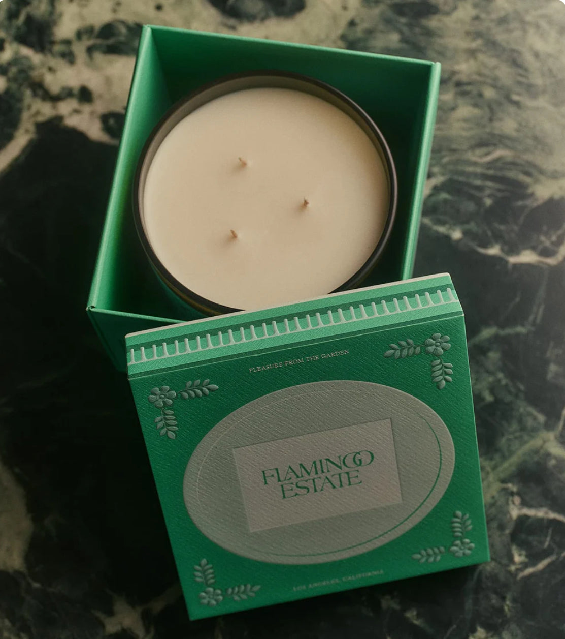 XL Candle in a green box with 'Flamingo Estate' branding on a marble surface