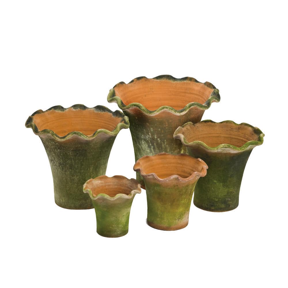 A set of five elegant ceramic scalloped planters in green and terracotta colors with a textured surface.