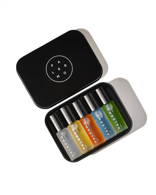 Set of five aromatherapy oil roll-ons in glass bottles, colorful in a black tin box, featuring the 'Palermo body' brand.