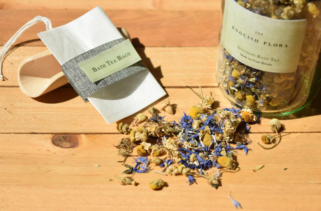 Bath tea bags and jar of English Flora soothing bath herbal tea on a wooden surface