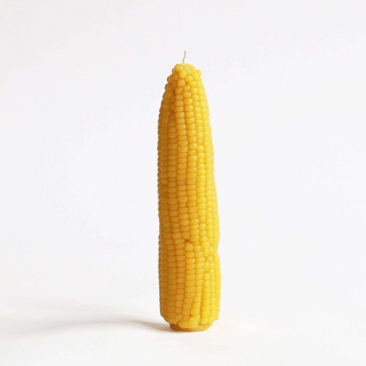 Corn-shaped candle on a white background