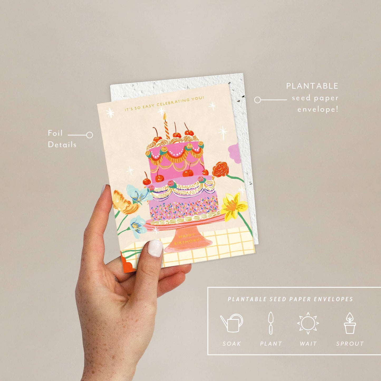 Hand holding a plantable seed paper envelope and a card with a colorful birthday cake illustration on a beige background