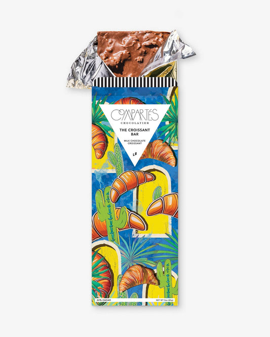 A gourmet milk chocolate bar with a decorative wrapper featuring a colorful croissant design.