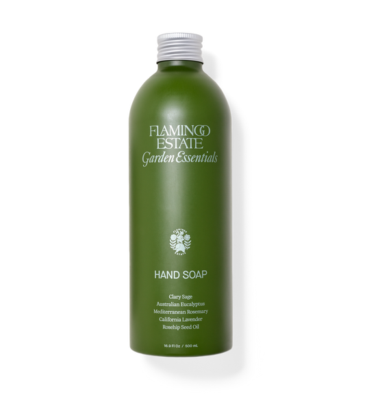 Green bottle of Flamingo Estate Garden Essentials Hand Soap on a white background