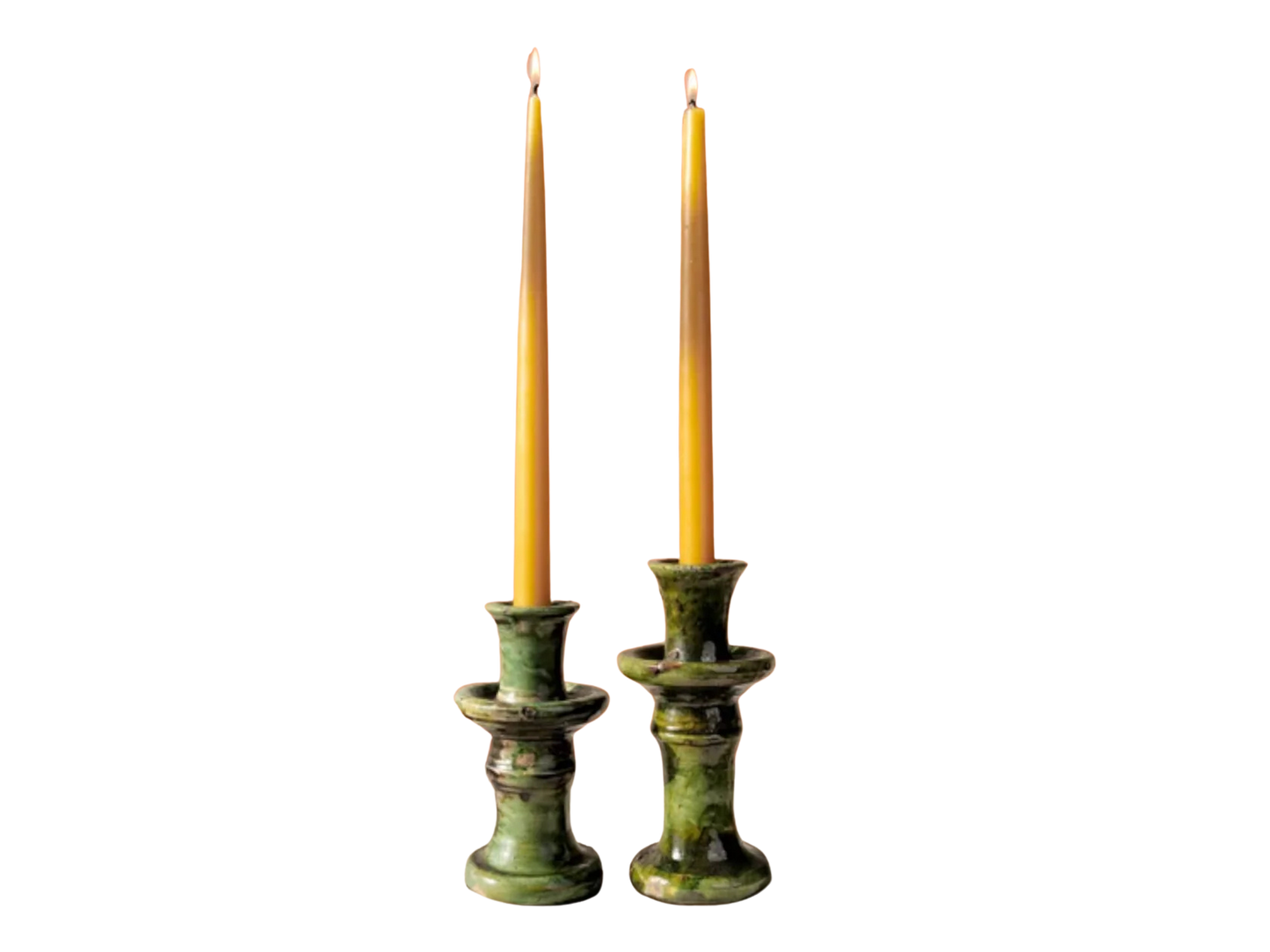 Two green tamegroute candle holders with candles on a white background