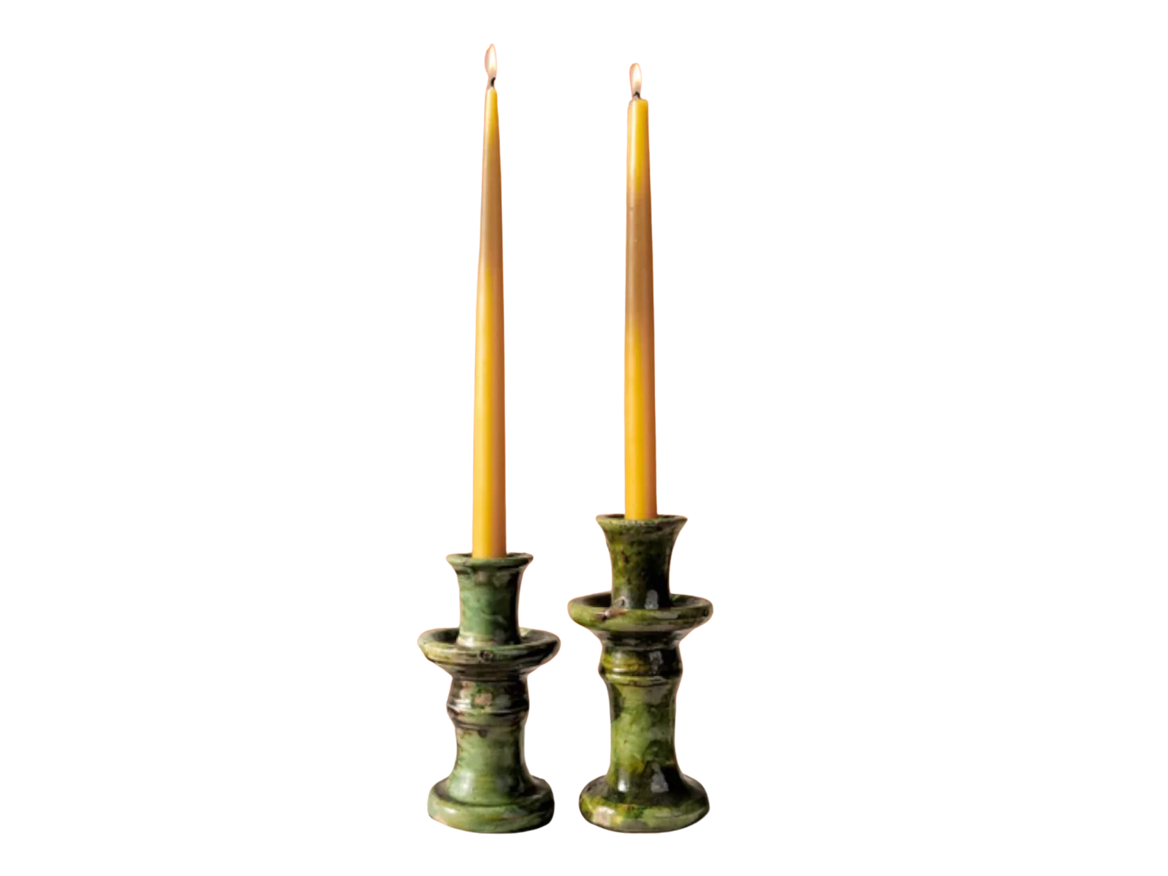 Two green tamegroute candle holders with candles on a white background