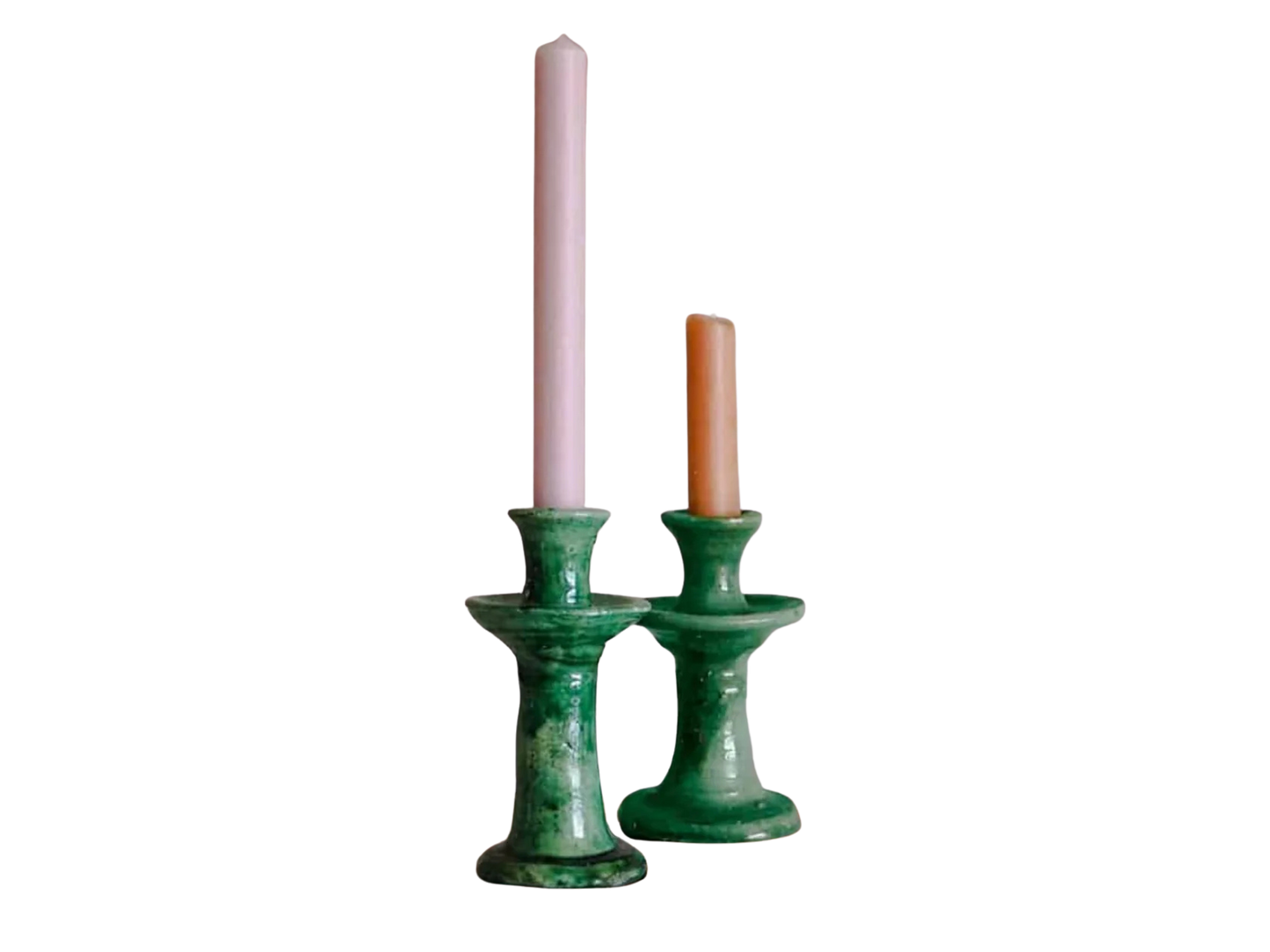 Two green tamegroute candle holders with candles on a white background