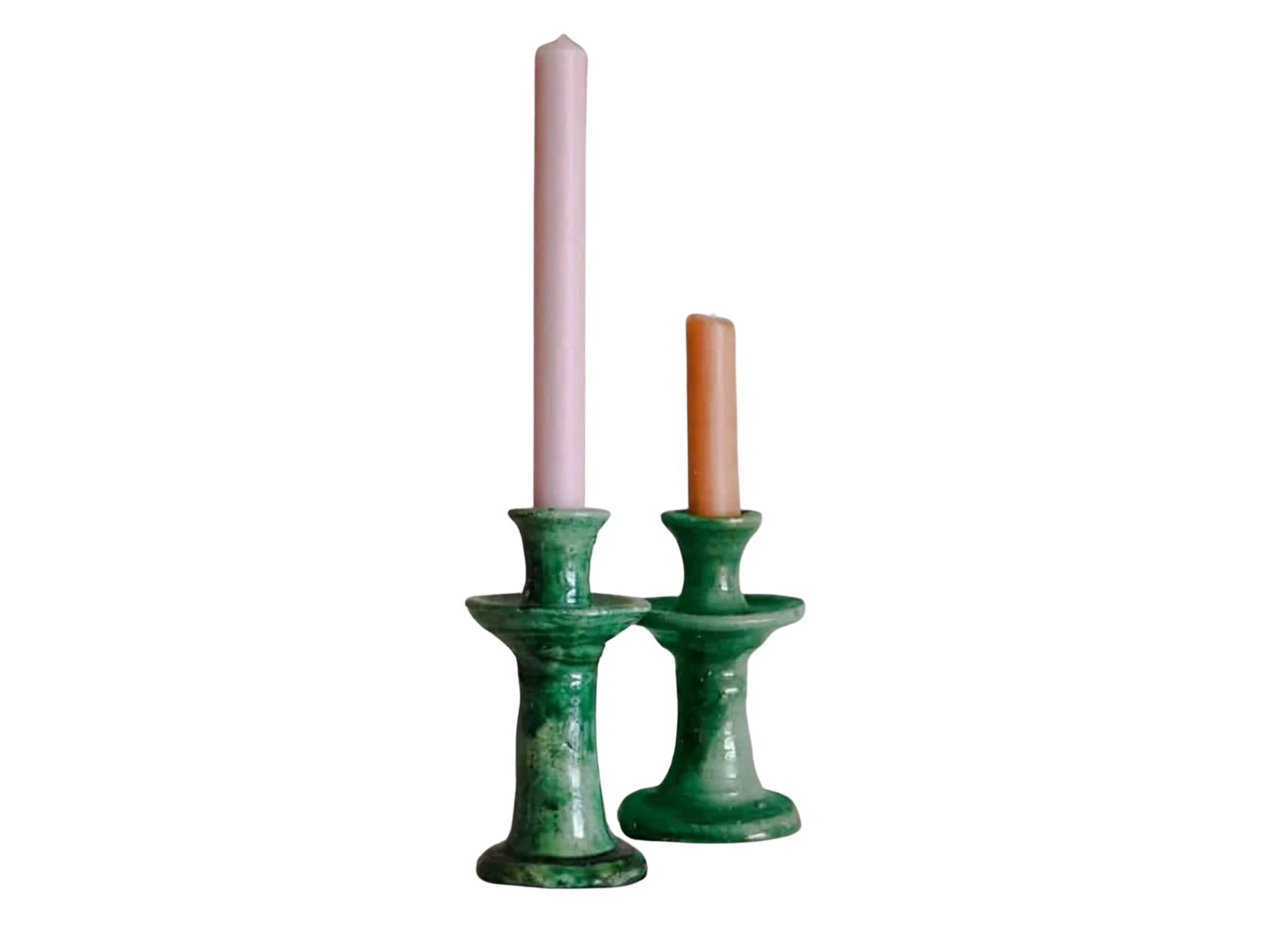 Two green tamegroute candle holders with candles on a white background
