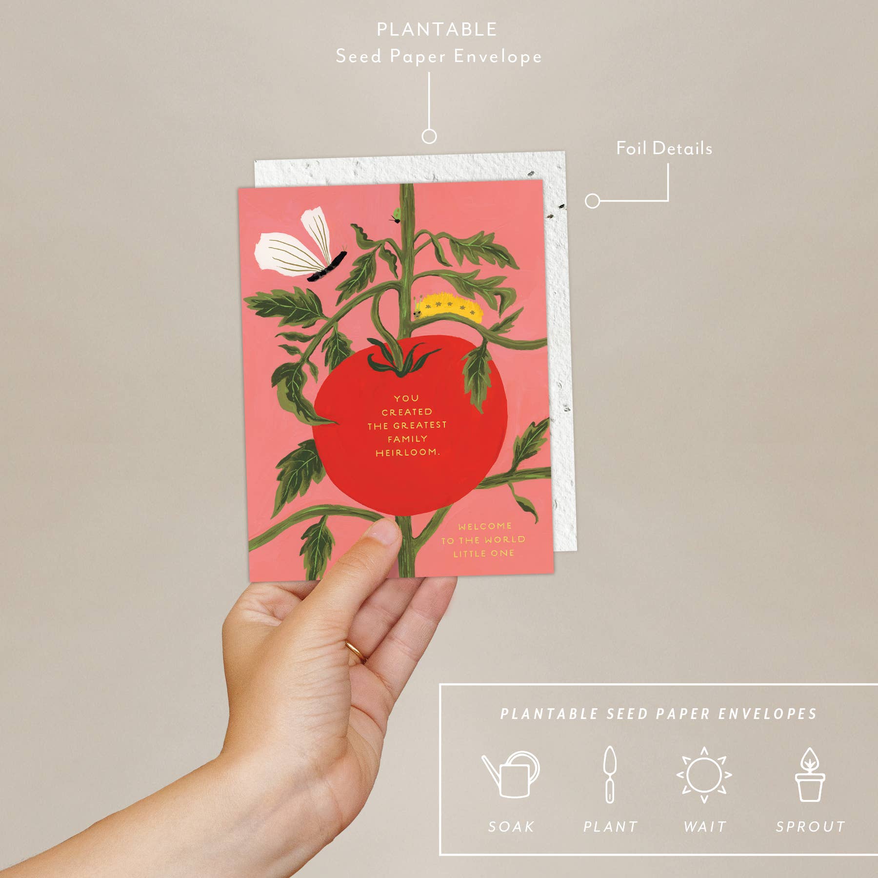 A hand holding a greeting card with a graphic of a tomato plant and a butterfly, with text that reads 'You created the greatest family heirloom. Welcome to the world little one', accompanied by a plantable seed paper envelope with eco-friendly packaging details.