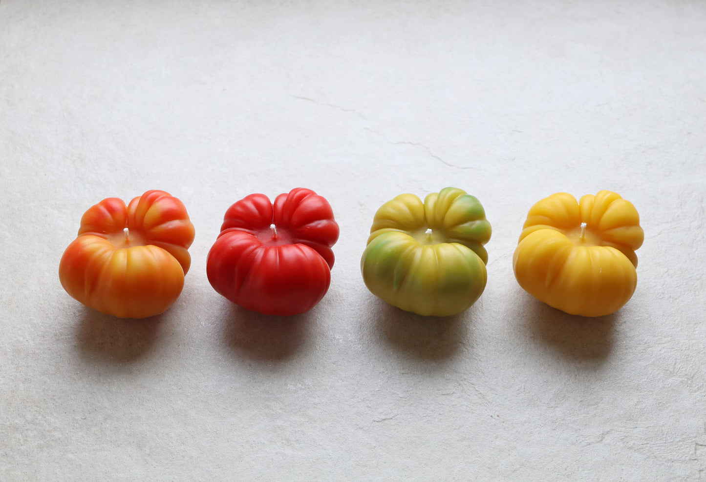 Eco-friendly beeswax candles from local farms, in various colors: orange, red, green and yellow