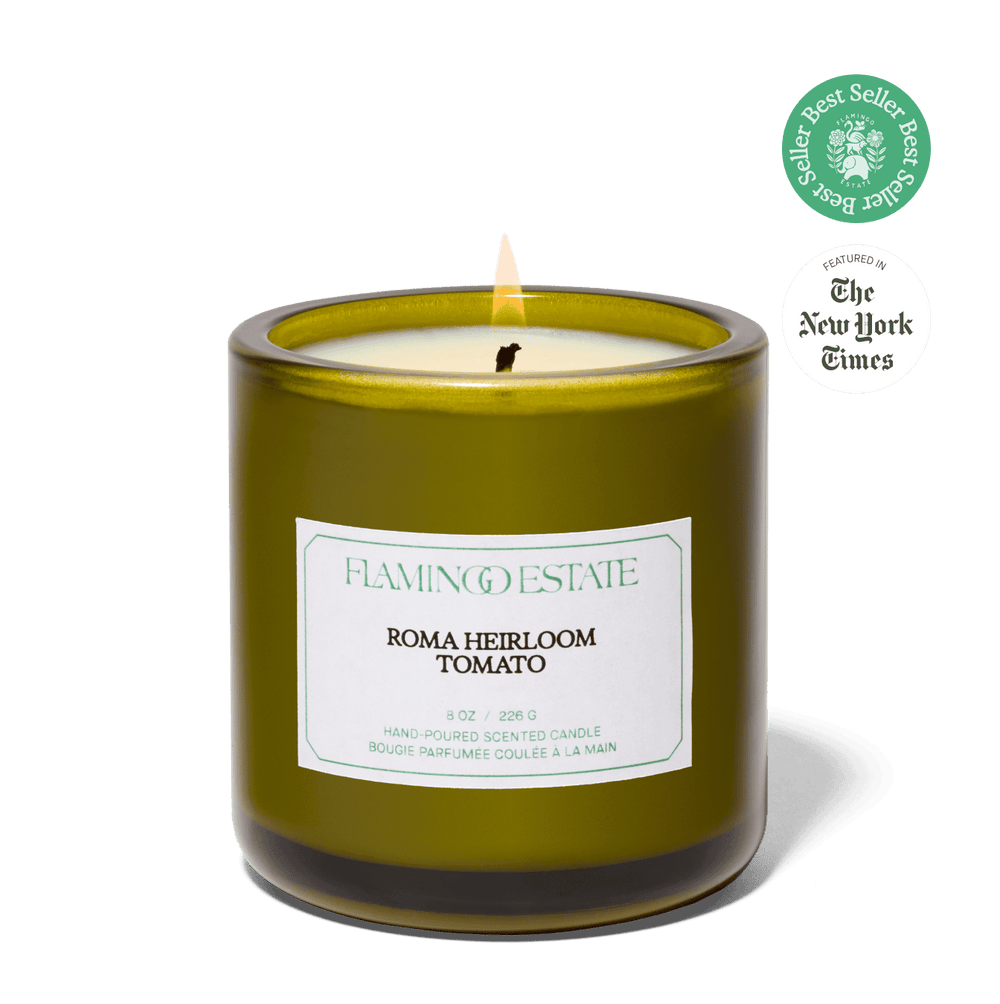 Green candle labeled 'Flamingo Estate Roma Heirloom Tomato' with a New York Times Best Seller badge on a green background.