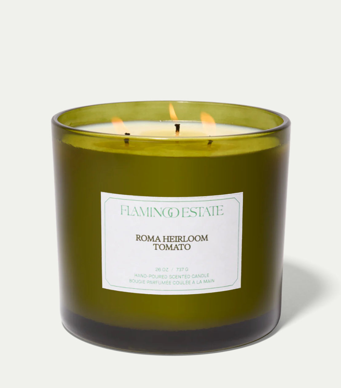 Green Heirloom Tomato XL candle with a Flamingo Estate label on a white background