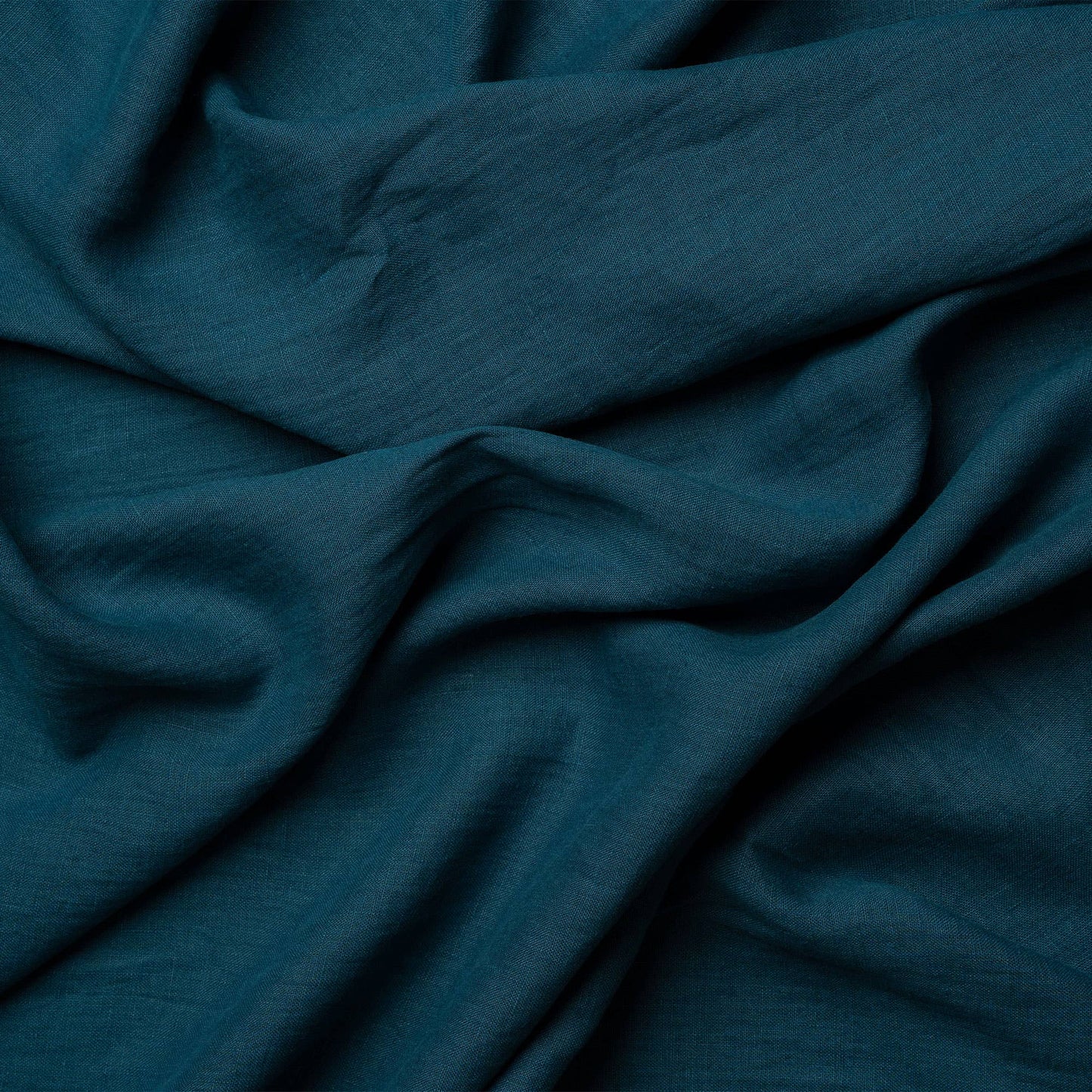 Close-up on the texture of a cobalt blue linen napkin from menique.