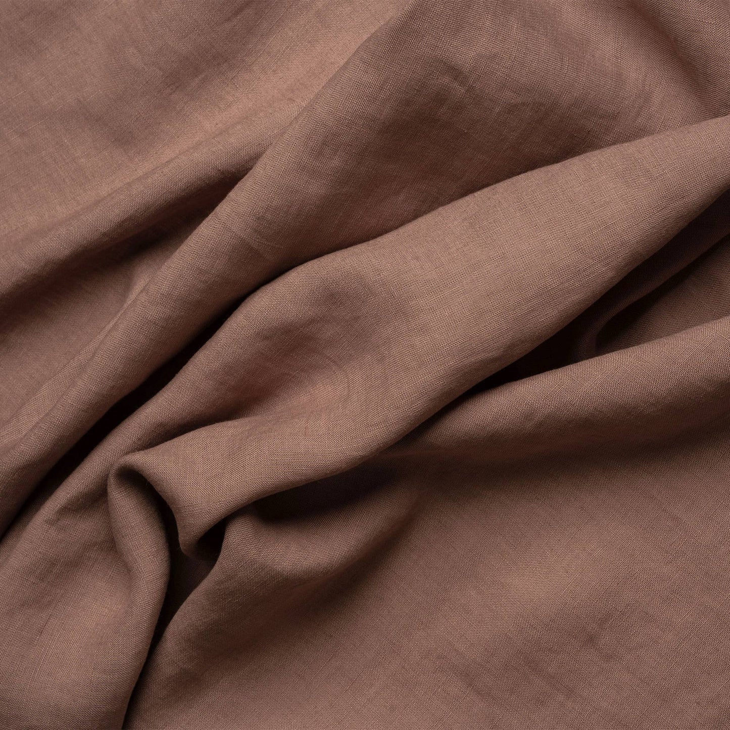 Close-up on the texture of a faded rose linen napkin from menique.