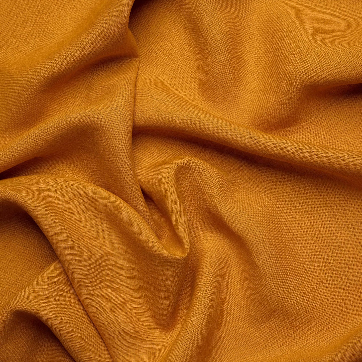 Close-up on the texture of a spicy yellow linen napkin from menique.