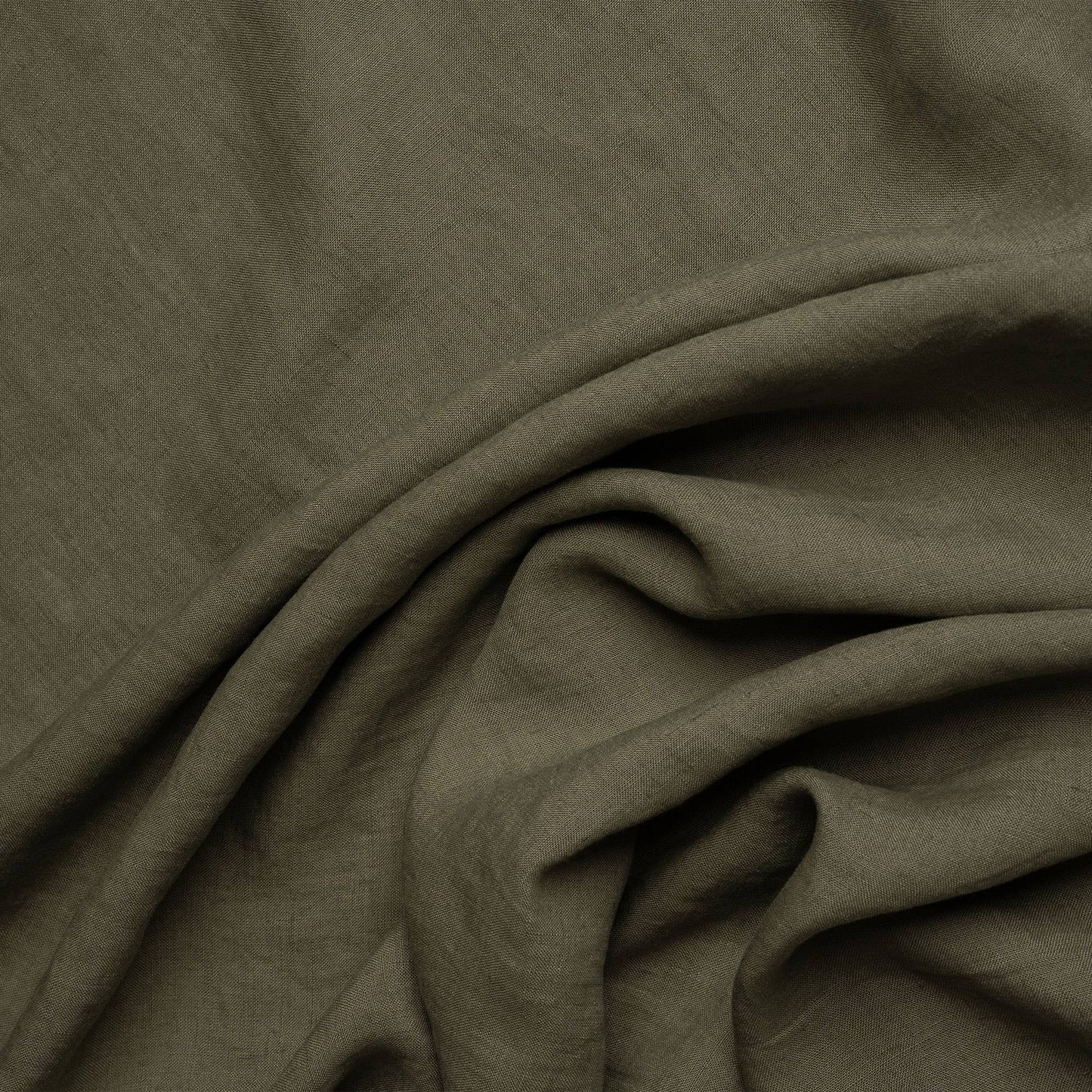 Close-up on the texture of a stone green linen napkin from menique.