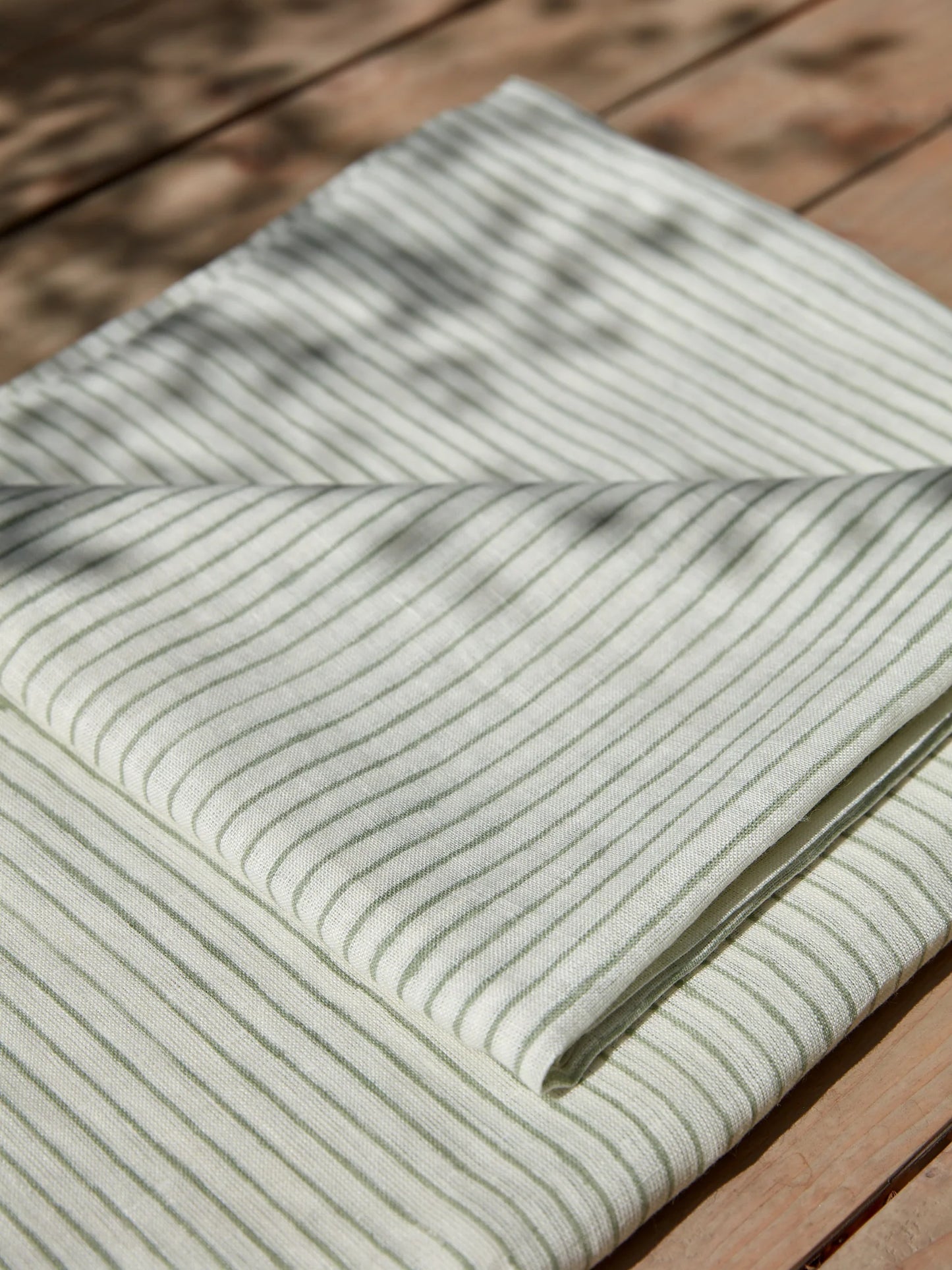 Striped linen tablecloth on a wooden surface