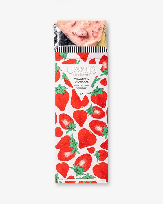 Gourmet white chocolate bar filled with real strawberries and shortcake chunks wrapped in a colourful strawberry packaging.
