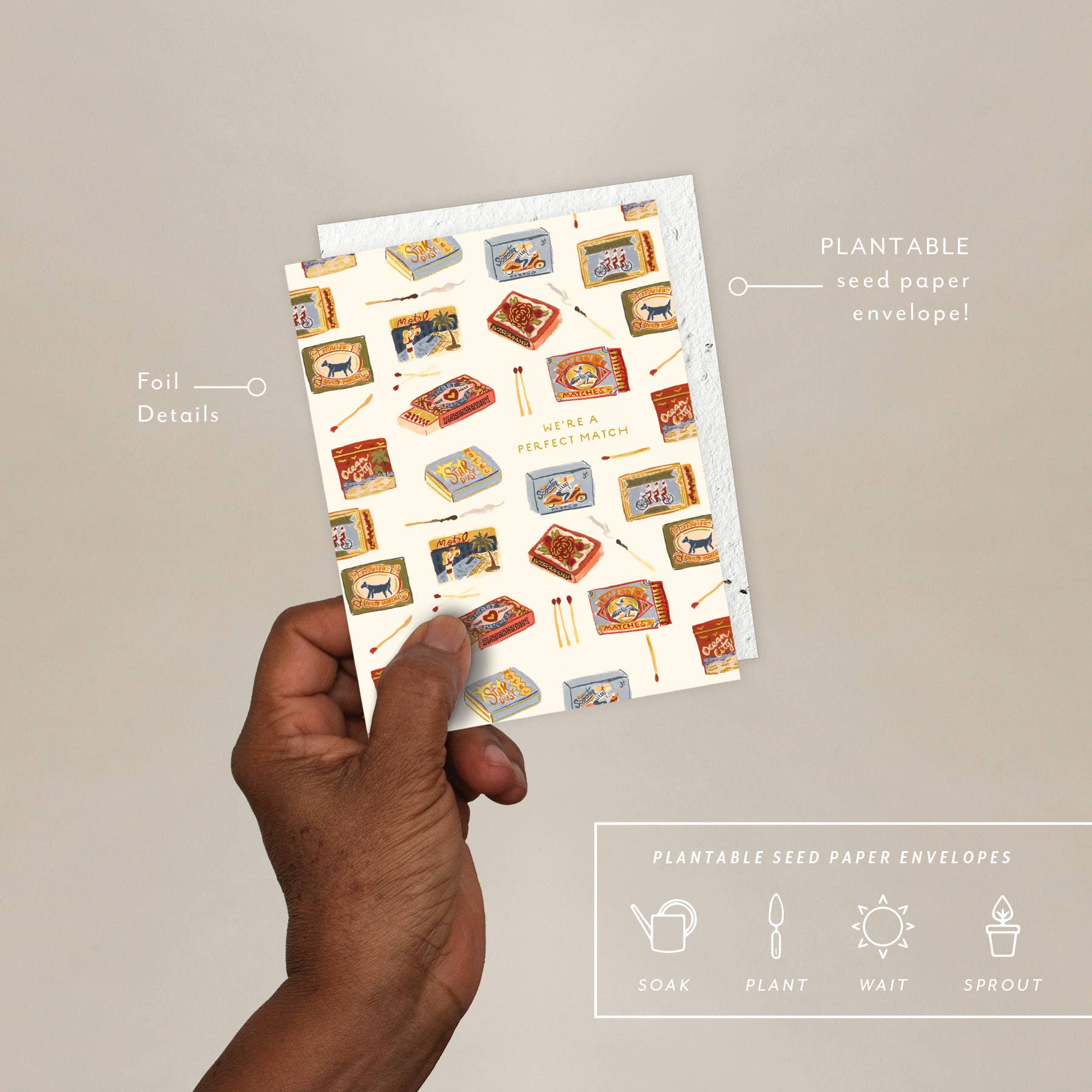 A hand holding a greeting card with an illustration displaying boxes of matches, accompanied by a plantable seed paper envelope with eco-friendly packaging details.