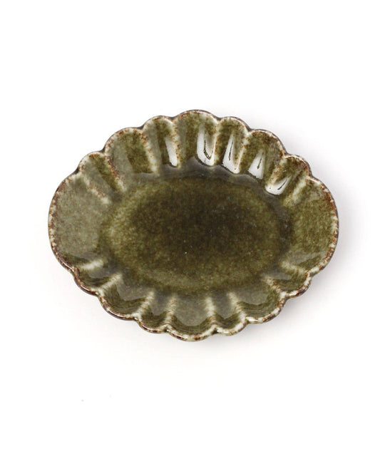 A mini oval chrysanthemum-shaped ceramic plate with a green tint and floral detailing on the rim.