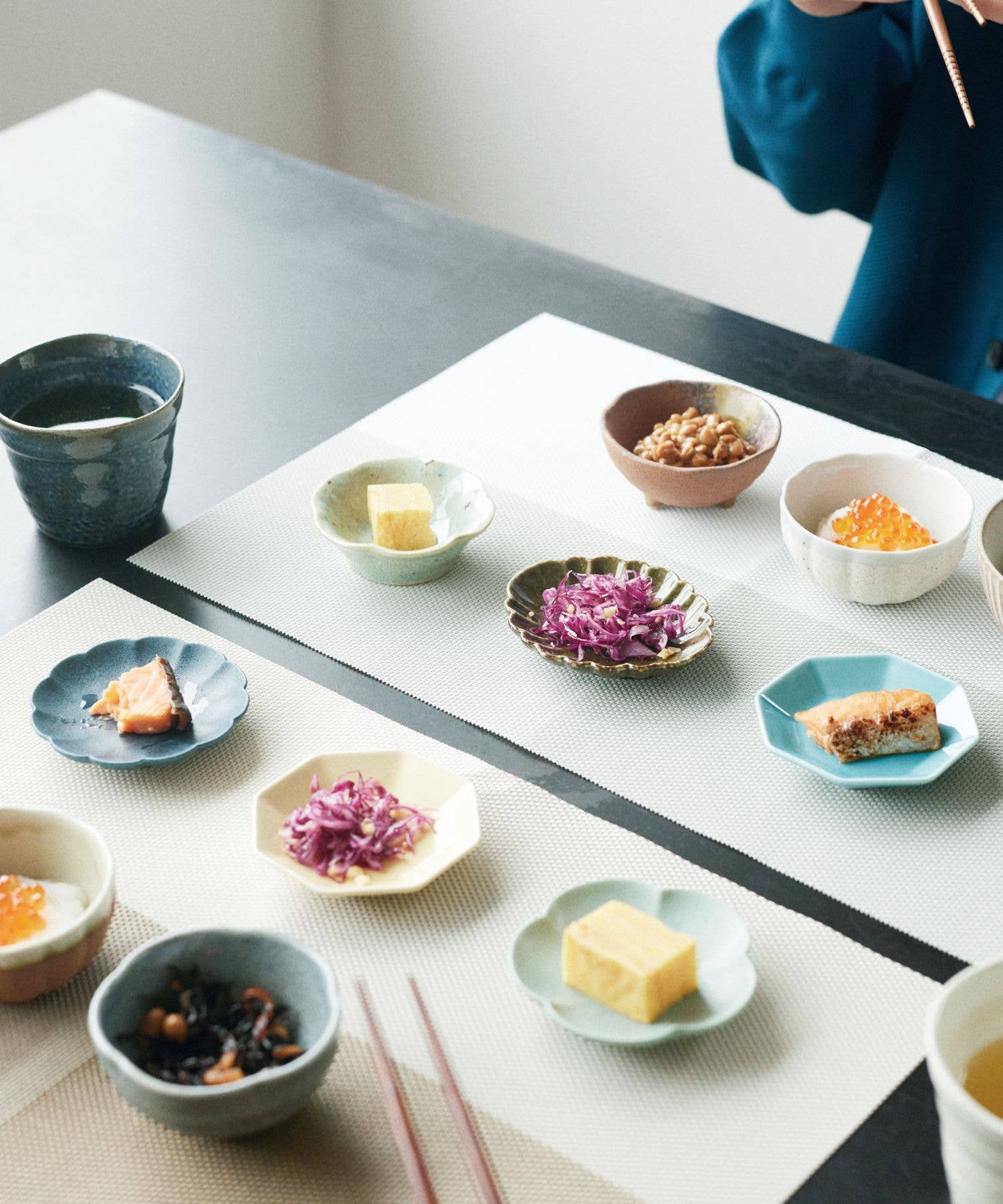 Mino ware display on a table with various condiments in multiple japanese ceramic mini bowls.