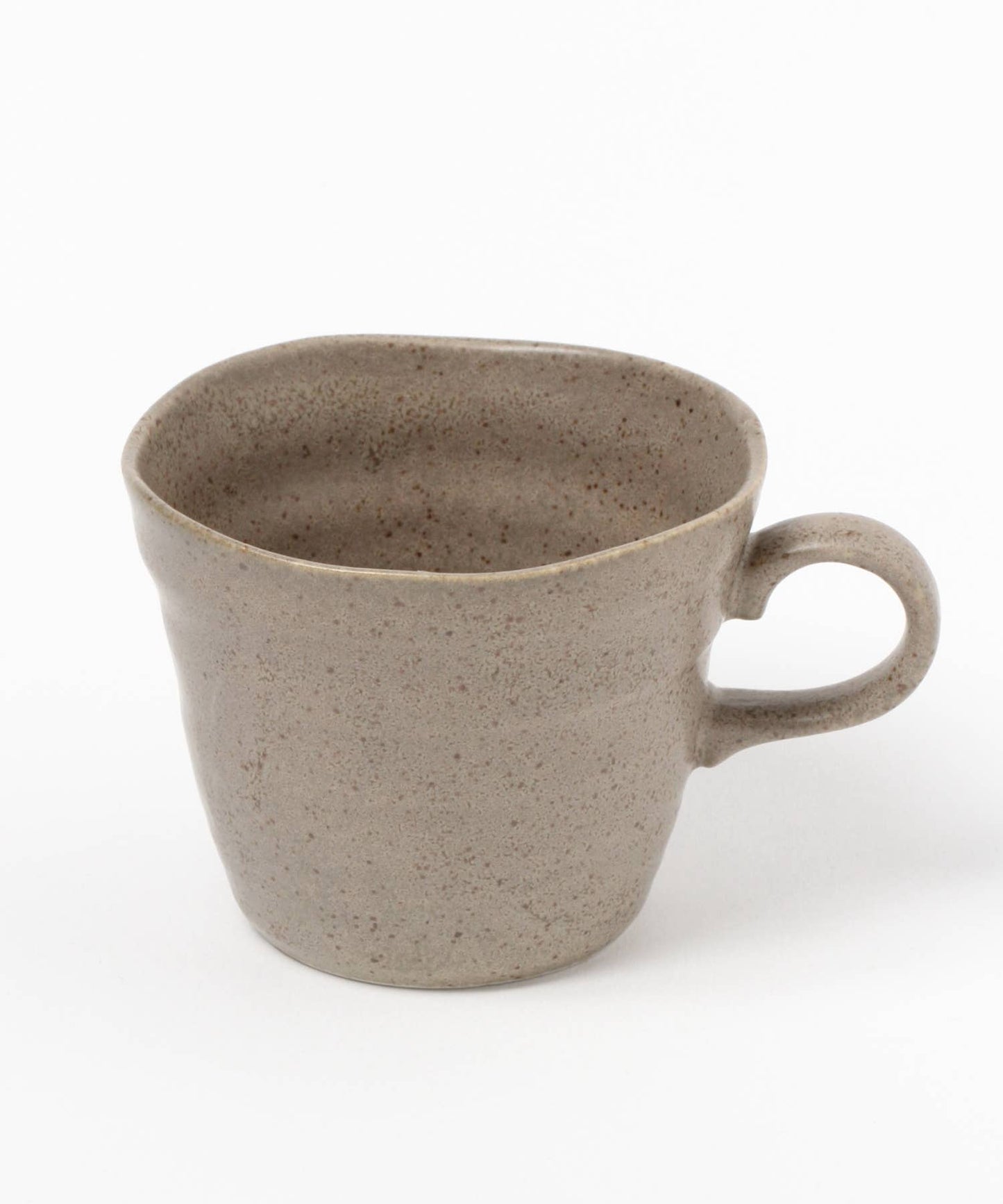 A beige ceramic mino ware mug with an organic shape on a white background.