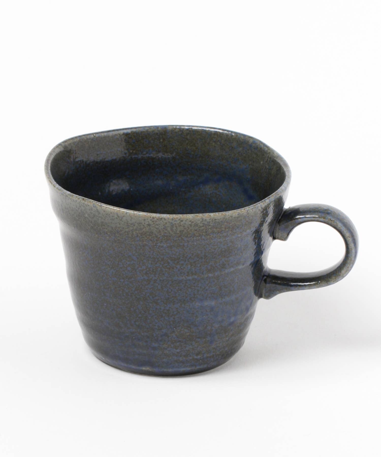 A dark blue ceramic mino ware mug with an organic shape on a white background.