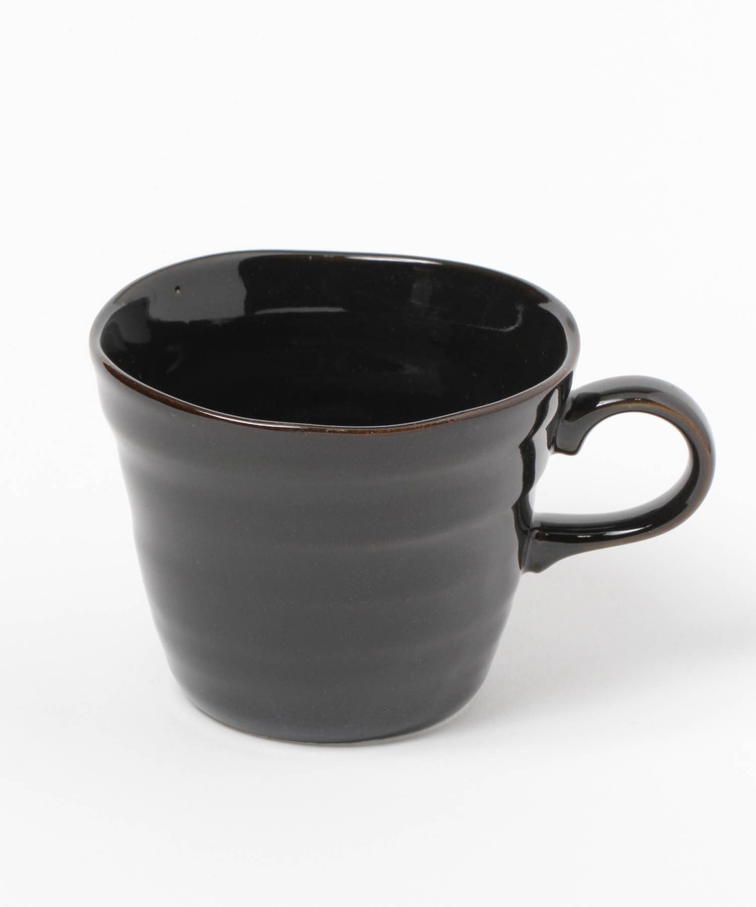 A gloss black ceramic mino ware mug with an organic shape on a white background.