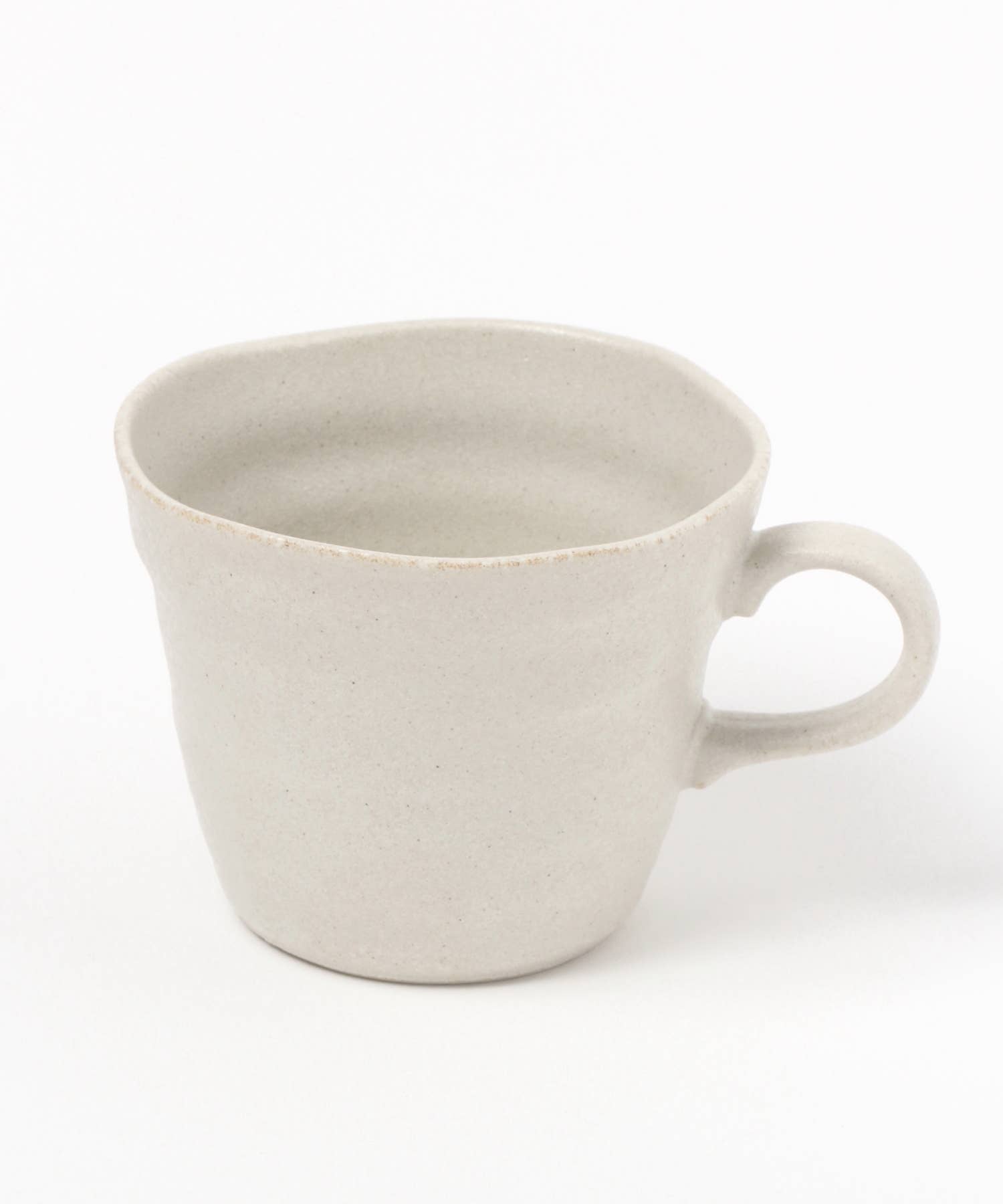 A white ceramic mino ware mug with an organic shape on a white background.