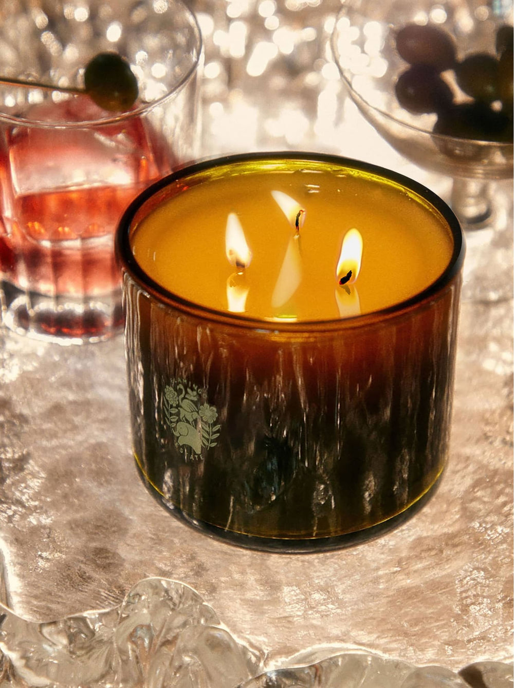 Candle in a decorative glass holder with a blurred background