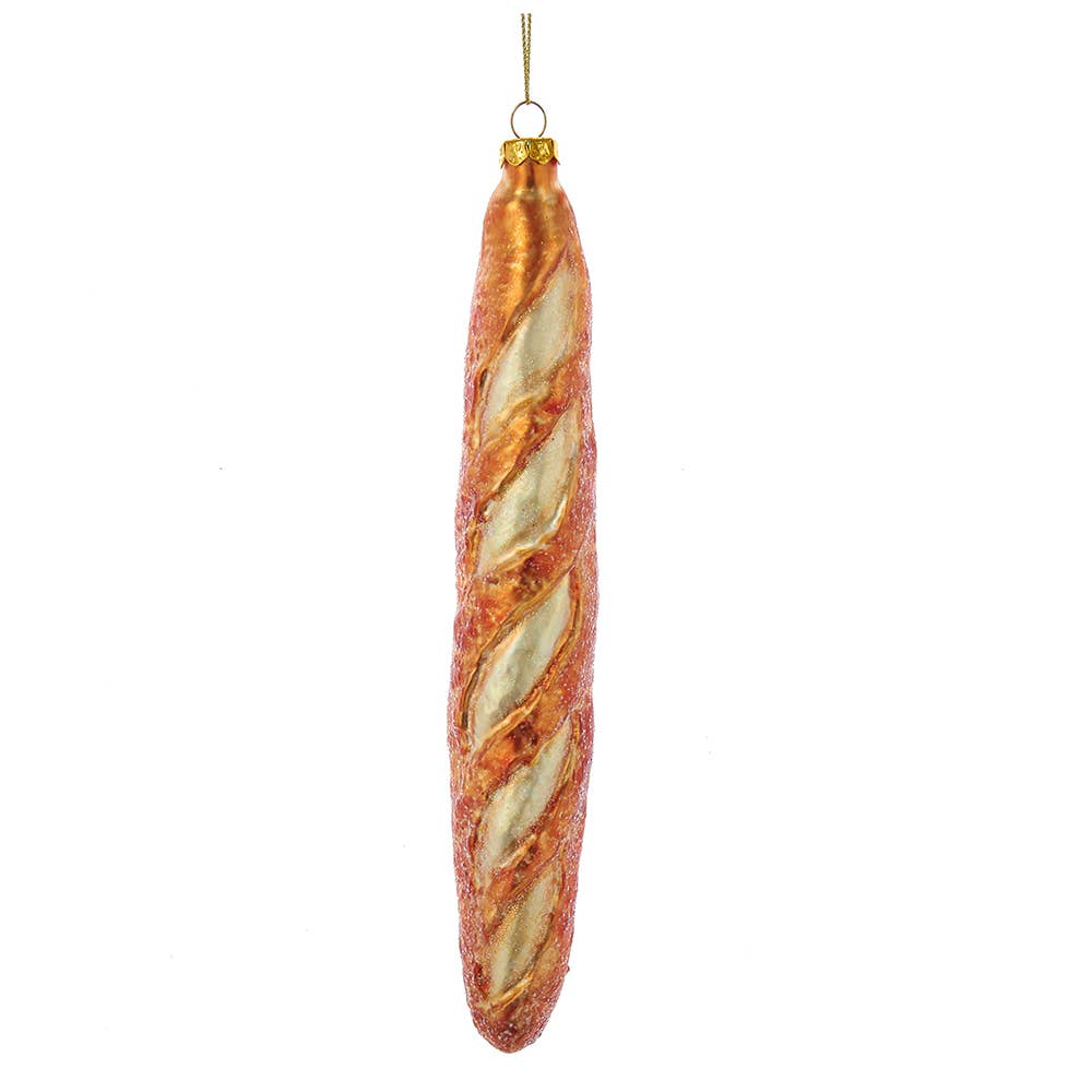A glass ornament designed to resemble a French baguette, with a golden hue and textured surface.