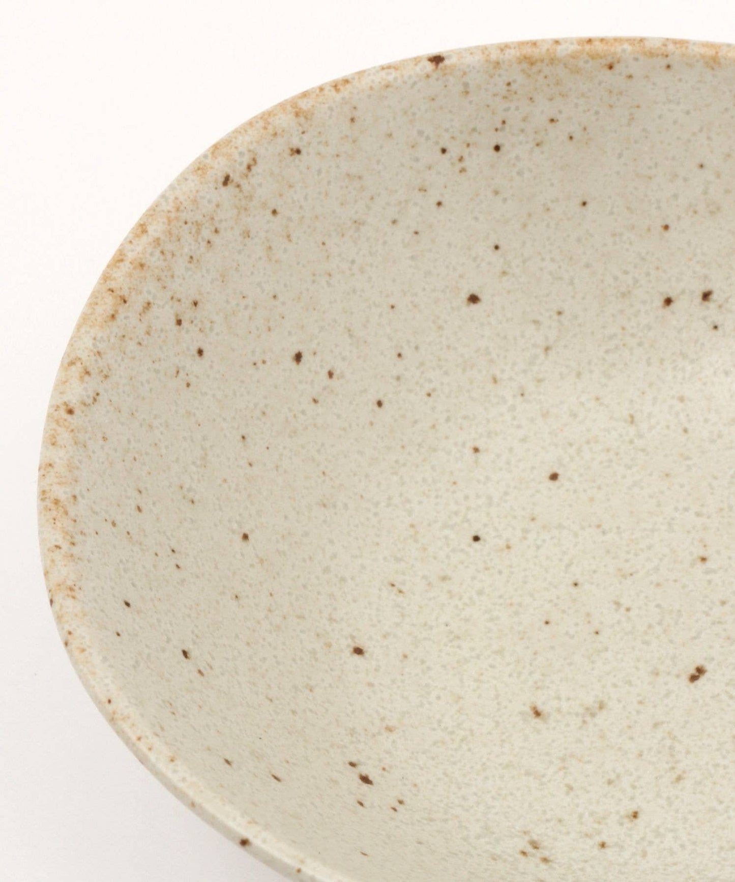 Close-up on a white ceramic mino ware mini bowl with an organic shape on a white background.