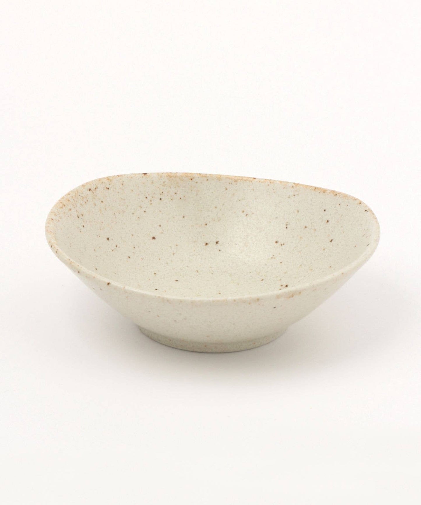 A white ceramic mino ware mini bowl with an organic shape on a white background.