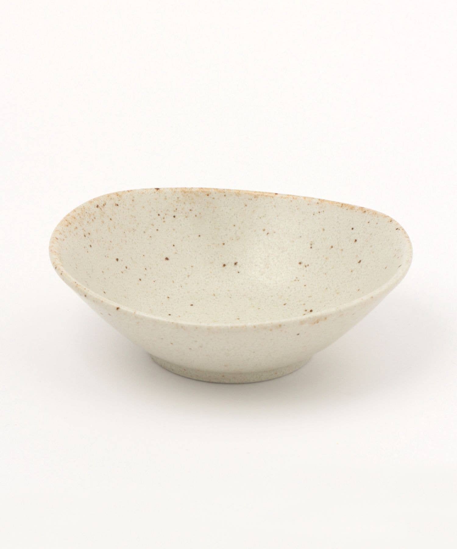 A white ceramic mino ware mini bowl with an organic shape on a white background.