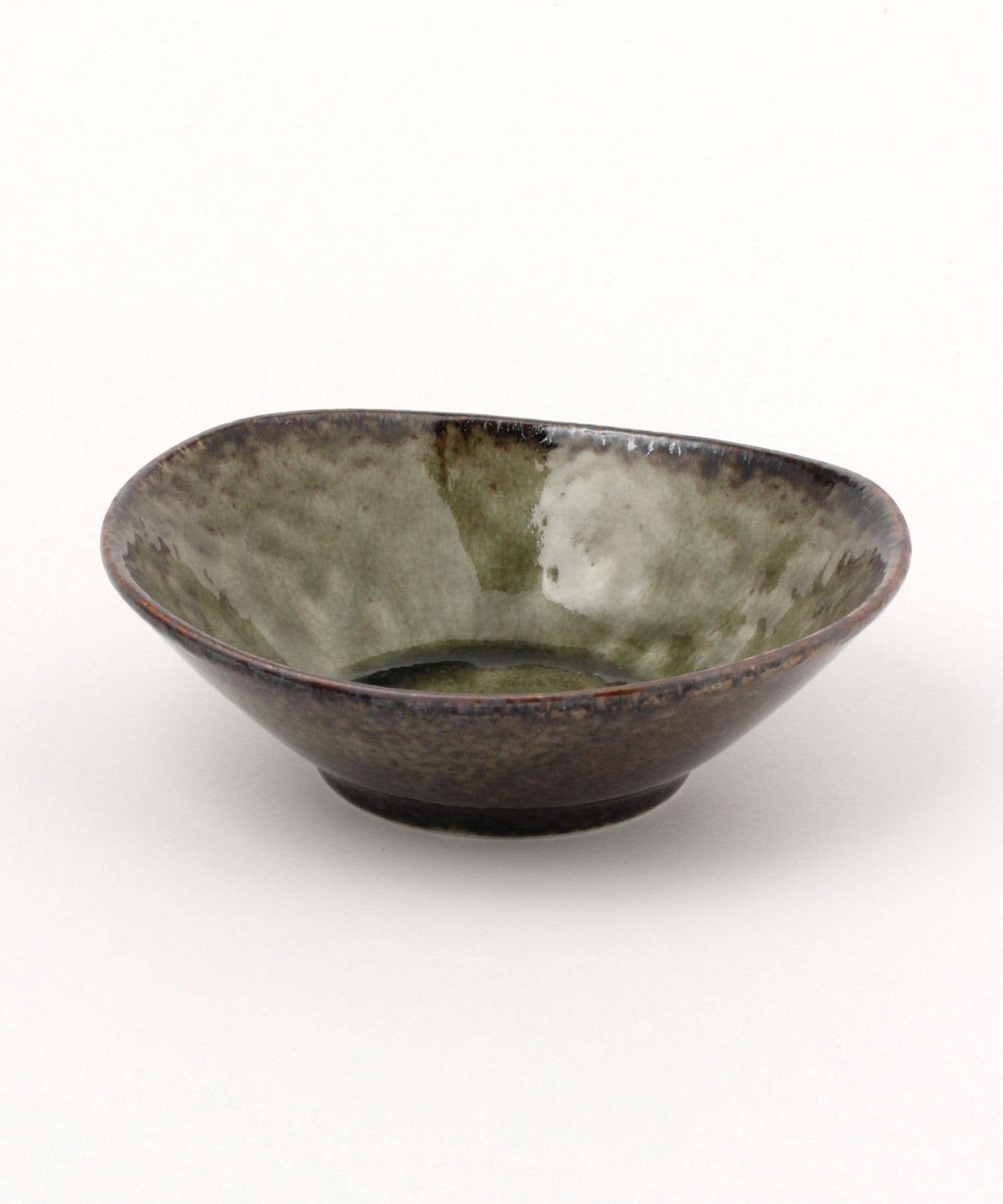 A moss green ceramic mino ware mini bowl with an organic shape on a white background.