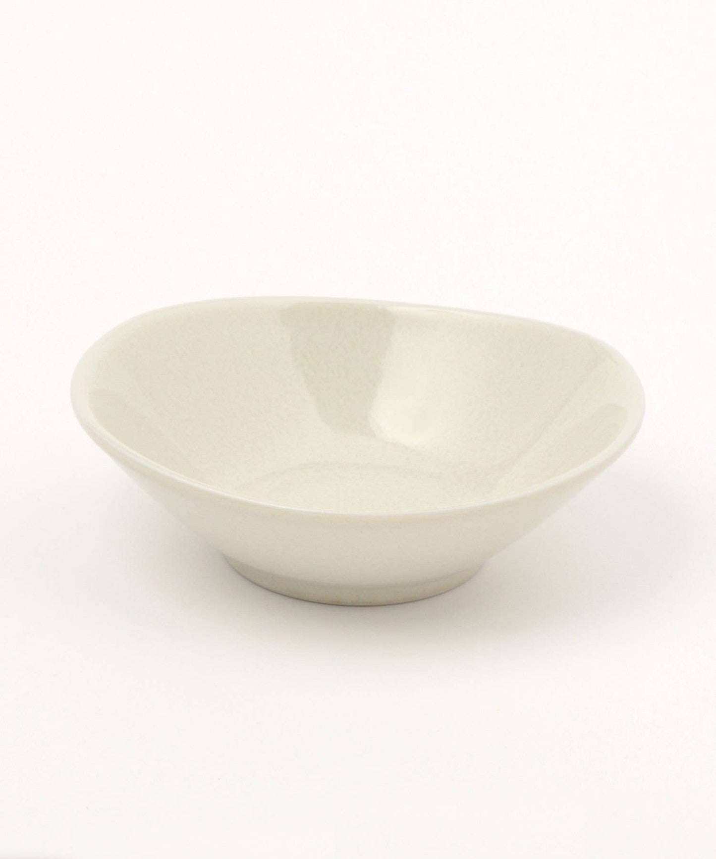 A gloss white ceramic mino ware mini bowl with an organic shape on a white background.