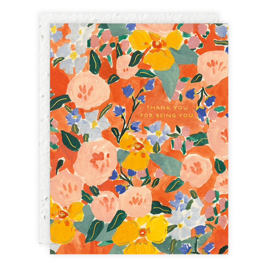 A floral patterned thank you card with orange, red, and yellow flowers and green leaves, with a thank you message in the center.