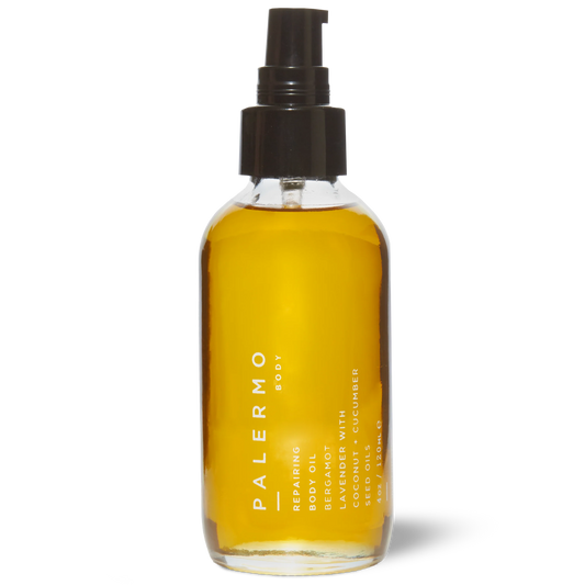 Bottle of Palermo body oil with a pump on a white background