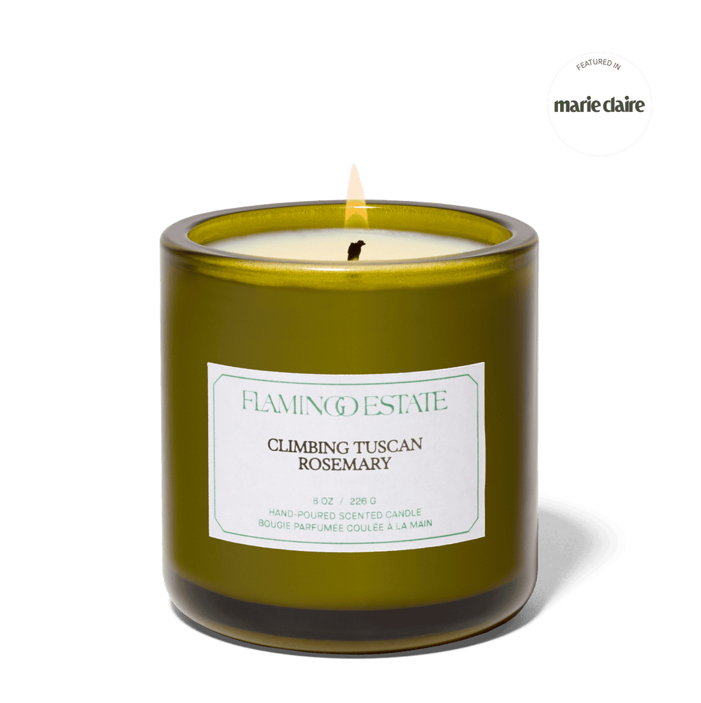 Candle with a label on a green background, featuring the Flamingo Estate brand.