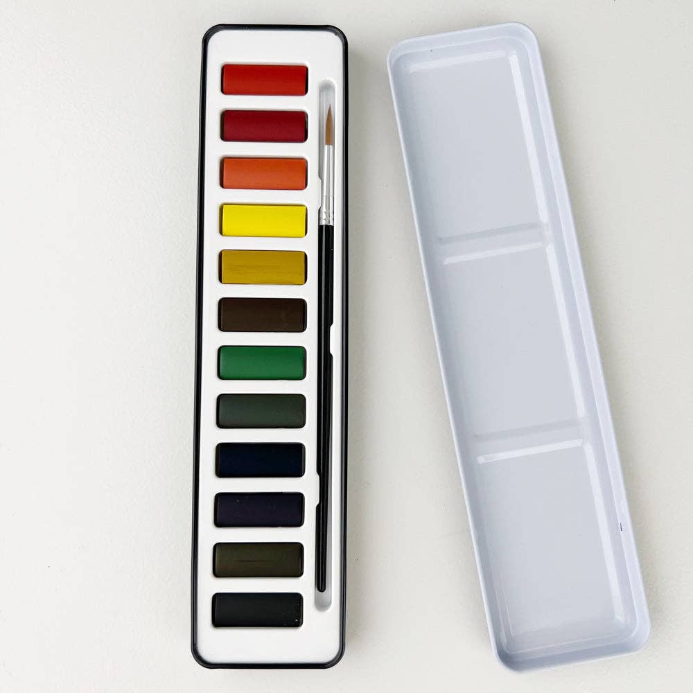 A watercolor paint set with 12 colors displayed in a black tin case alongside a round size 4 brush, with the lid of the tin case used as a mixing palette.