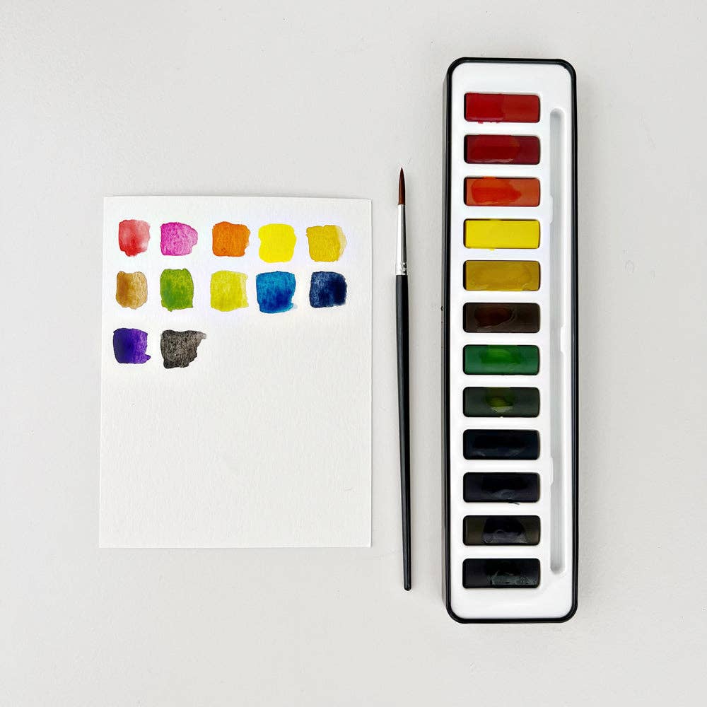 A watercolor paint set with 12 colors displayed in a black tin case alongside a round size 4 watercolor brush, with color swatches on a paper.