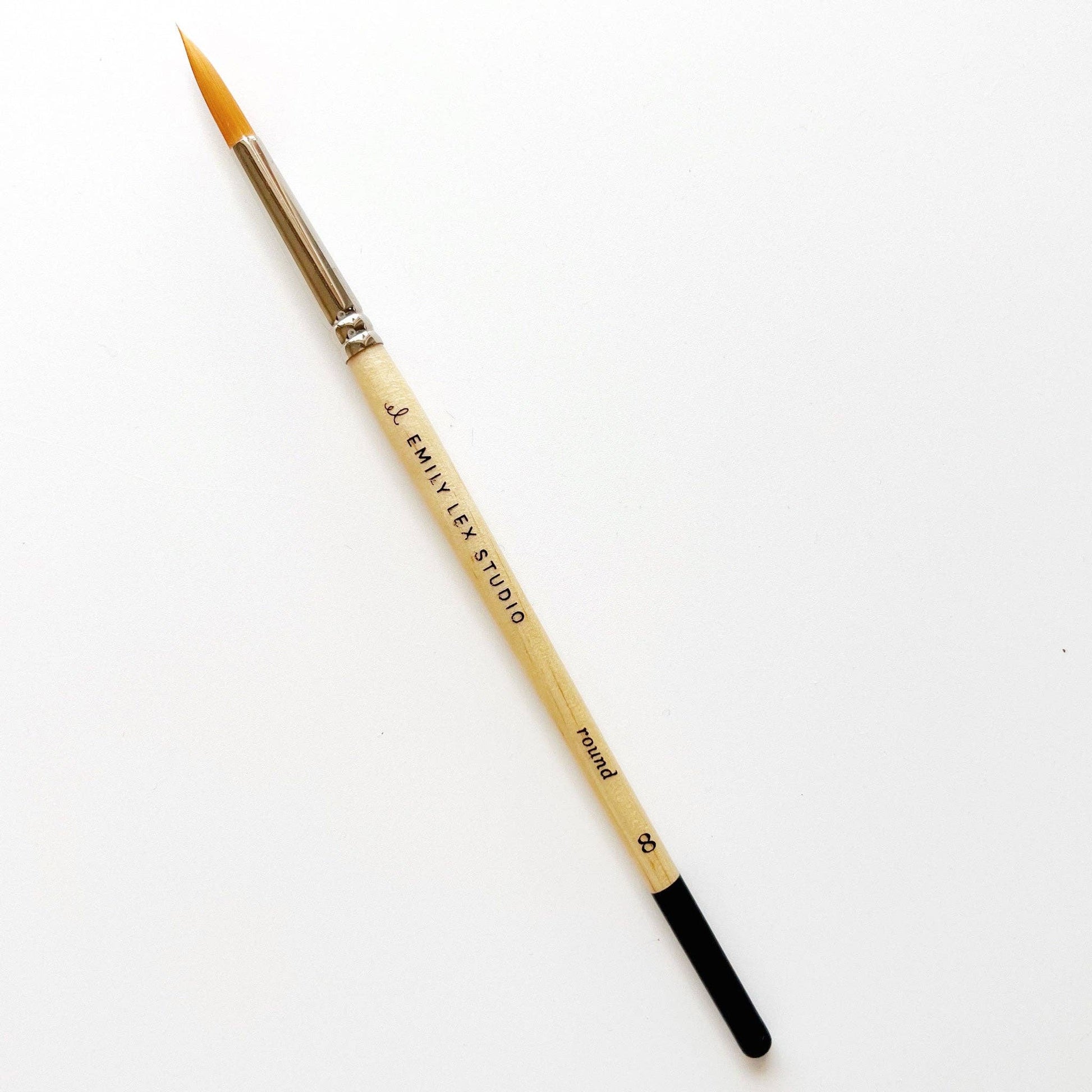 A watercolor paintbrush with golden synthetic taklon bristles, seamless aluminum ferrules, and lacquered wood handles, from emily lex studio, size 8, great for the bulk of the paintings.