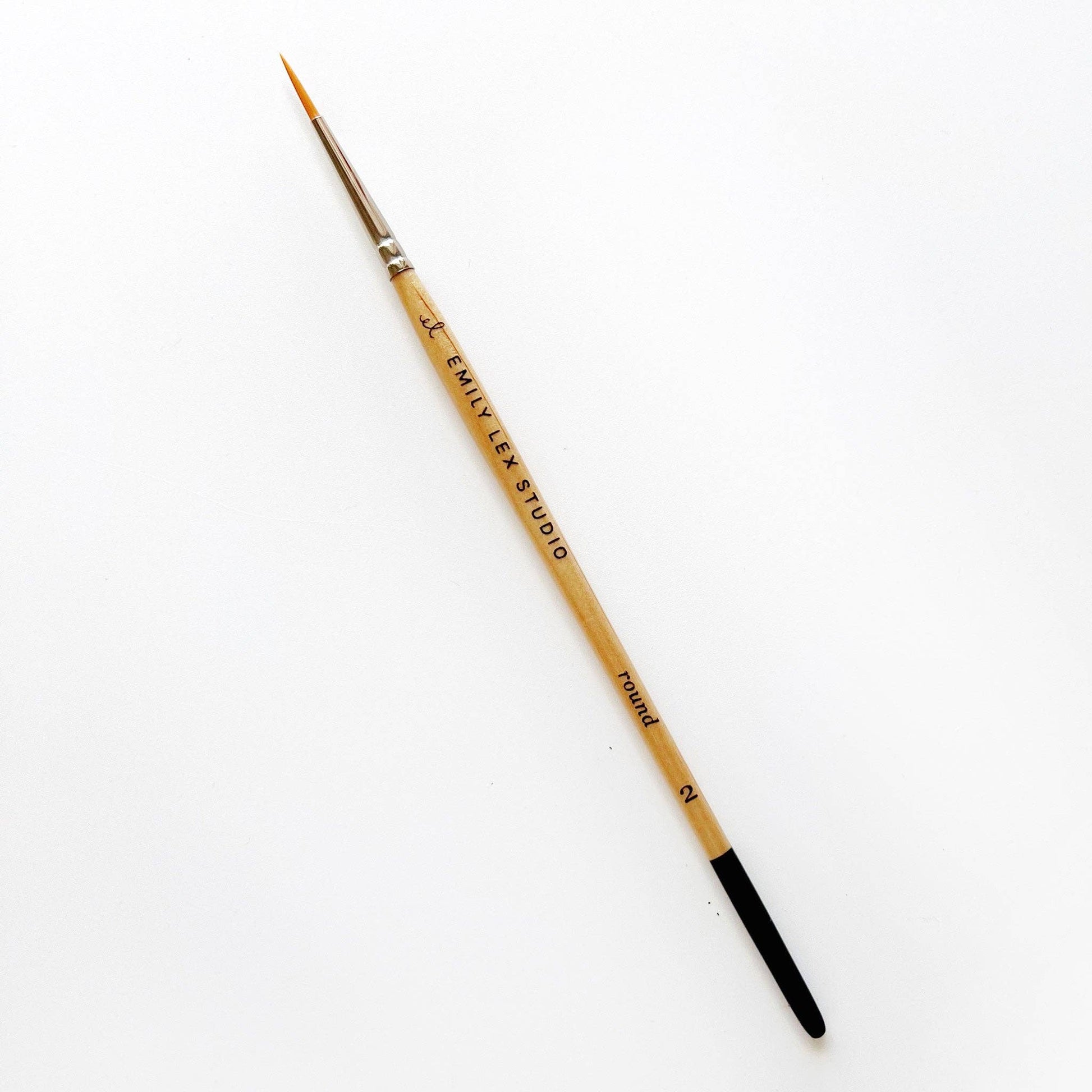A watercolor paintbrush with golden synthetic taklon bristles, seamless aluminum ferrules, and lacquered wood handles, from emily lex studio, size 2, great for small marks.