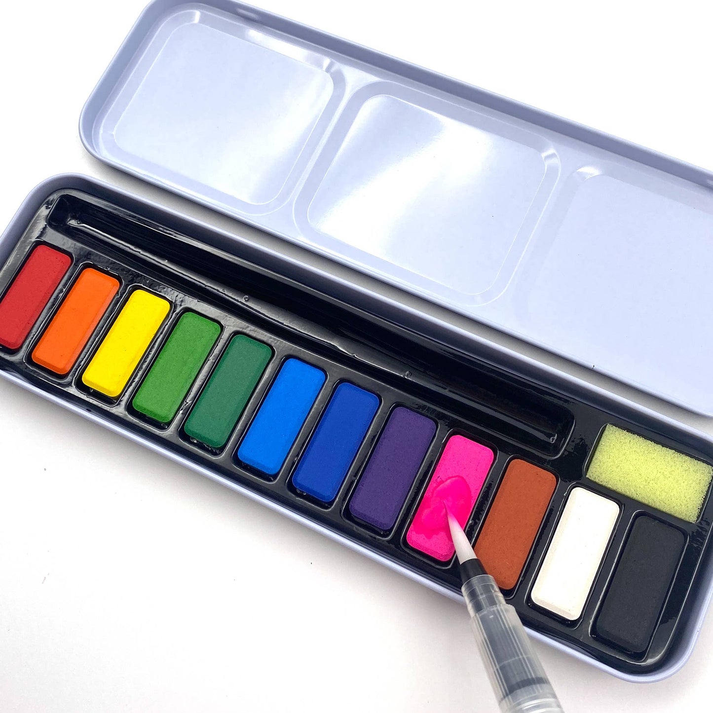 Set of watercolor paints with a brush on a white background
